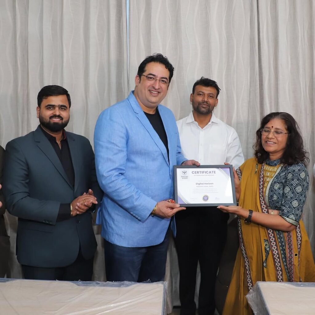 Amita Gupta receiving a certificate at a professional Digital Horizon event while standing with team members during an award and recognition ceremony